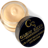 Eye cream jar with black lid featuring 'Glow Skin Enhancement' branding on a white background